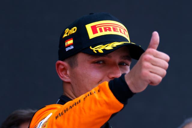Lando Norris gives a thumbs-up to the Spanish crowd