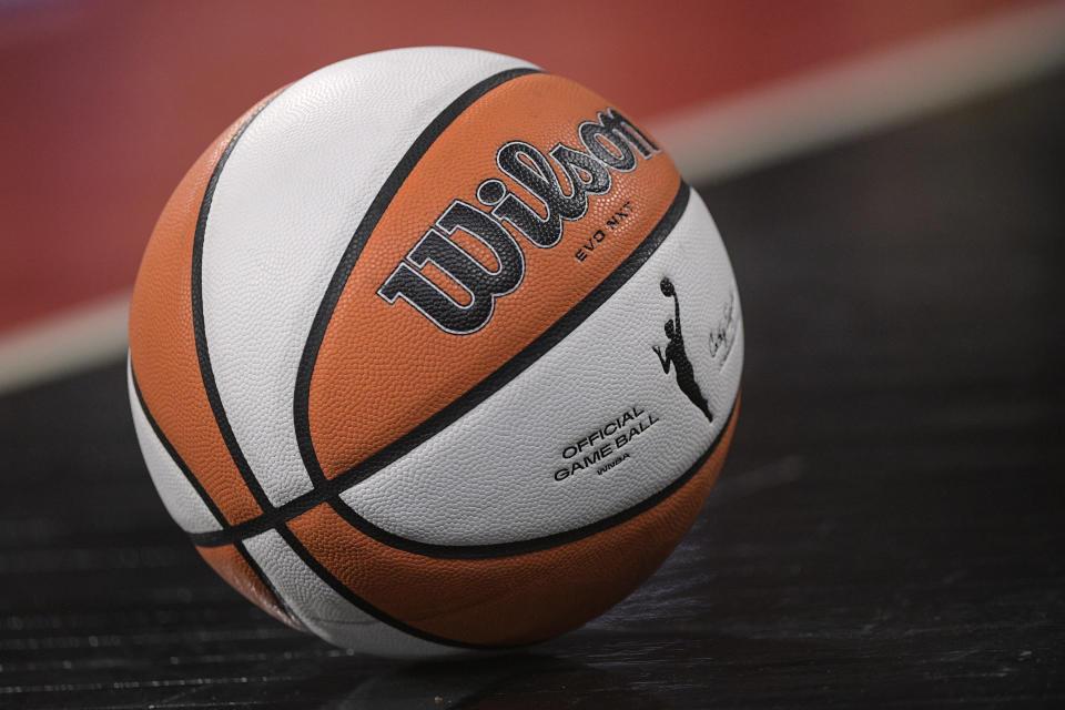 A regulation WNBA basketball rests on the floor during the first half of a WNBA basketball game between the Las Vegas Aces and Seattle Storm, Sunday, Aug. 14, 2022, in Las Vegas. (AP Photo/Sam Morris)