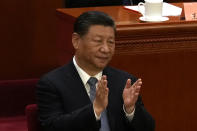 Chinese President Xi Jinping applauds during the opening session of the Chinese People's Political Consultative Conference in the Great Hall of the People in Beijing, Monday, March 4, 2024. (AP Photo/Ng Han Guan)