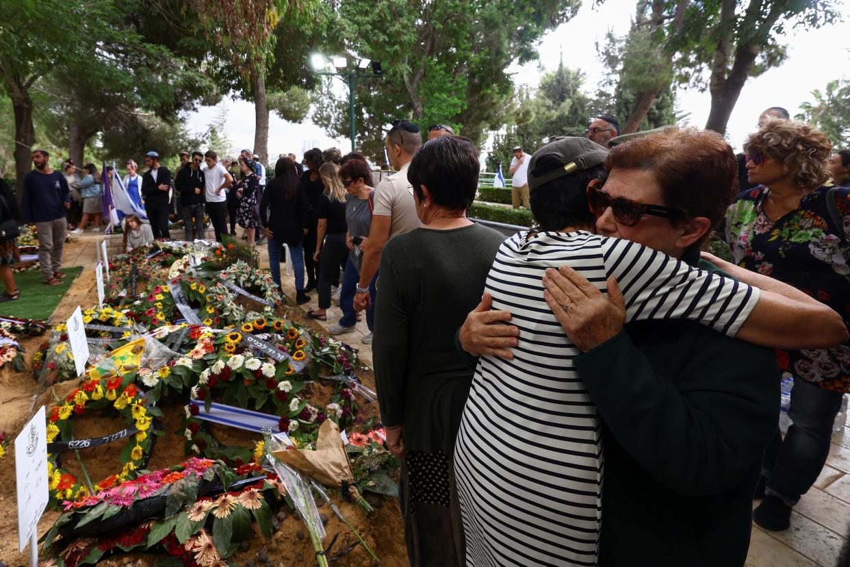 Two elderly women hug as they mourn Dvir Lisha, 21, an Israeli soldier who was killed during Hamas’s attacks (REUTERS)