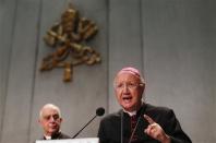 Bishop Carlo Maria Celli (R) speaks next to Bishop Rino Fisichella (L) during a presentation of the Evangelii Gaudium (The Joy of the Gospel) from Pope Francis, during a news conference in the Vatican November 26, 2013. REUTERS/Alessandro Bianchi