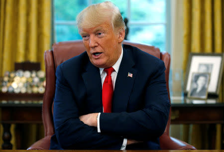 U.S. President Donald Trump answers a question during an interview with Reuters in the Oval Office of the White House in Washington, U.S. August 20, 2018. REUTERS/Leah Millis