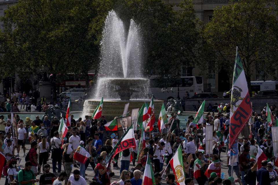 Demonstrators hold flags as they gather in Trafalgar Square, in London, Saturday, Sept. 16, 2023, as today marks the anniversary of the death of Mahsa Amini in Iran. (AP Photo/Alberto Pezzali)