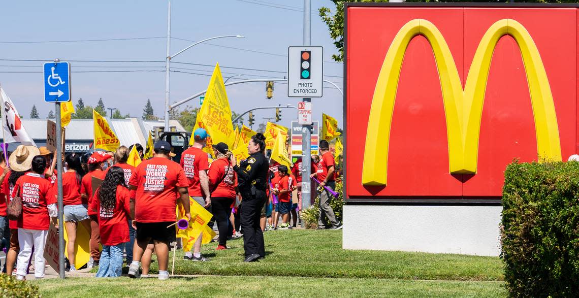 Fast-food cooks and cashiers protest outside of a McDonald’s in North Highlands on Tuesday in support for Assembly Bill 257, which would raise wages and set workplace standards.