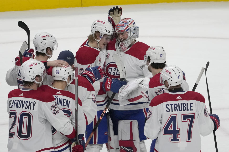 Montreal Canadiens goaltender Cayden Primeau, top right, is congratulated by teammates after an NHL hockey game against the San Jose Sharks in San Jose, Calif., Friday, Nov. 24, 2023. The Canadiens won 3-2 in a shootout. (AP Photo/Jeff Chiu)