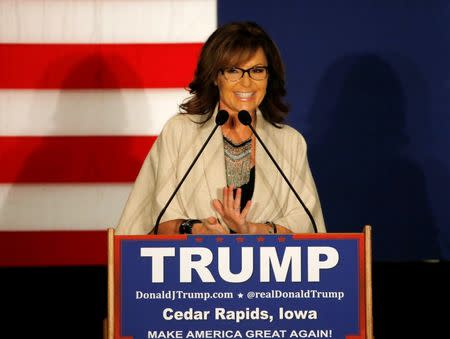 Former Alaska Gov. Sarah Palin stands at the podium as she awaits the arrival of U.S. Republican presidential candidate Donald Trump during a campaign rally in Cedar Rapids, Iowa February 1, 2016. REUTERS/Carlos Barria