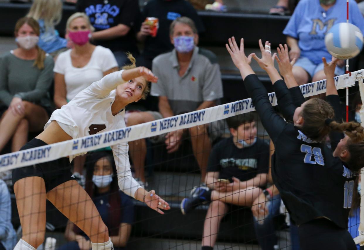 Assumption's Sydney Helmers (4) goes for a kill shot against Mercy Academy during their volleyball match at Mercy Academy in Louisville, Ky. on Sep. 7, 2021.