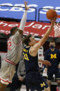 Michigan's Franz Wagner, right, makes a basket past Ohio State's E.J. Liddell during the second half of an NCAA college basketball game Sunday, Feb. 21, 2021, in Columbus, Ohio. (AP Photo/Jay LaPrete)