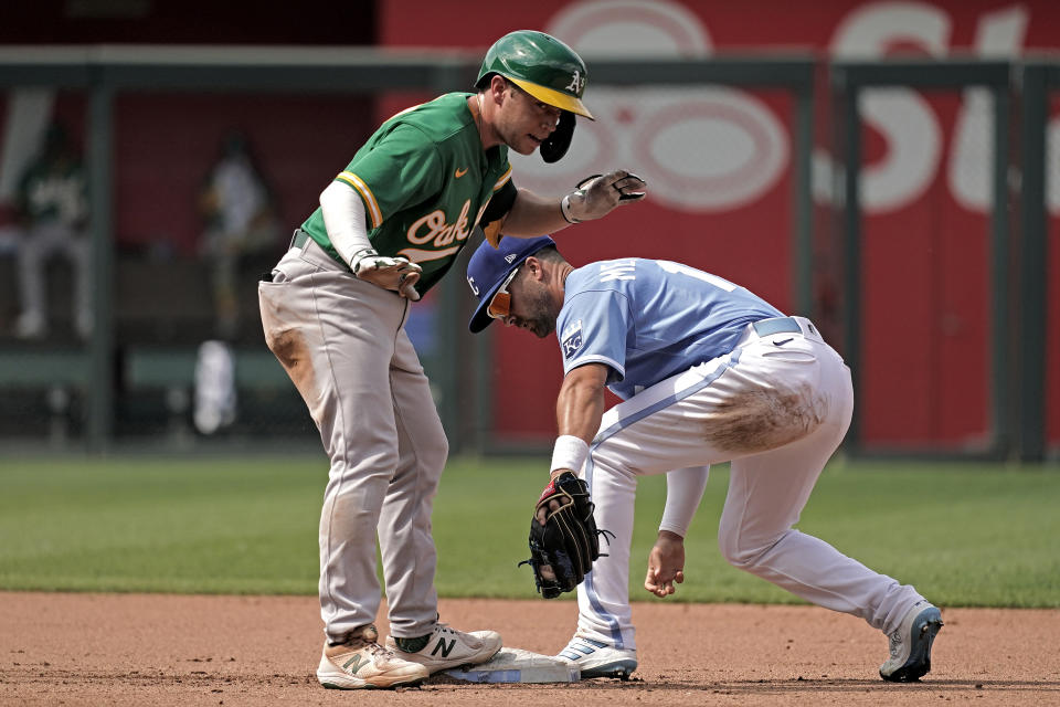 Oakland Athletics' Nick Allen beats the tag at second by Kansas City Royals second baseman Whit Merrifield after hitting an RBI double during the fourth inning of a baseball game Saturday, June 25, 2022, in Kansas City, Mo. (AP Photo/Charlie Riedel)