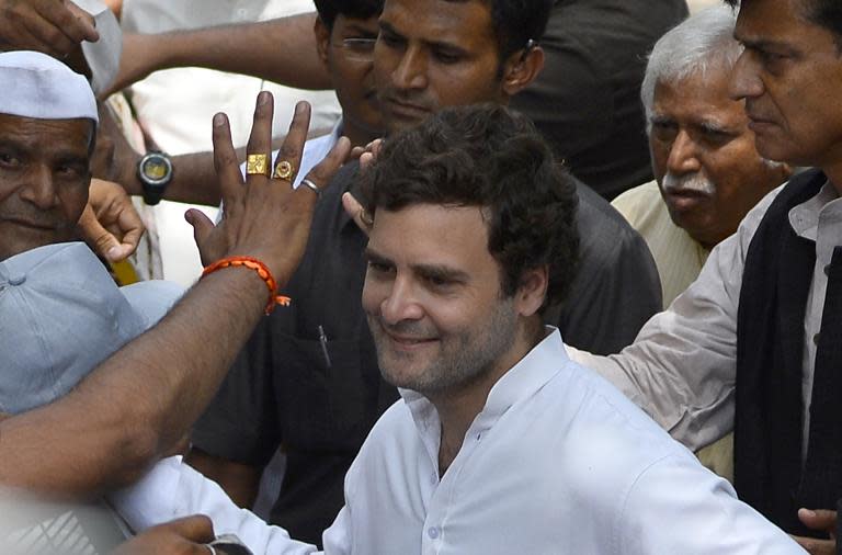 Indian Congress Party vice-president Rahul Gandhi meets farmers during a meeting outside his residence in New Delhi on April 18, 2015