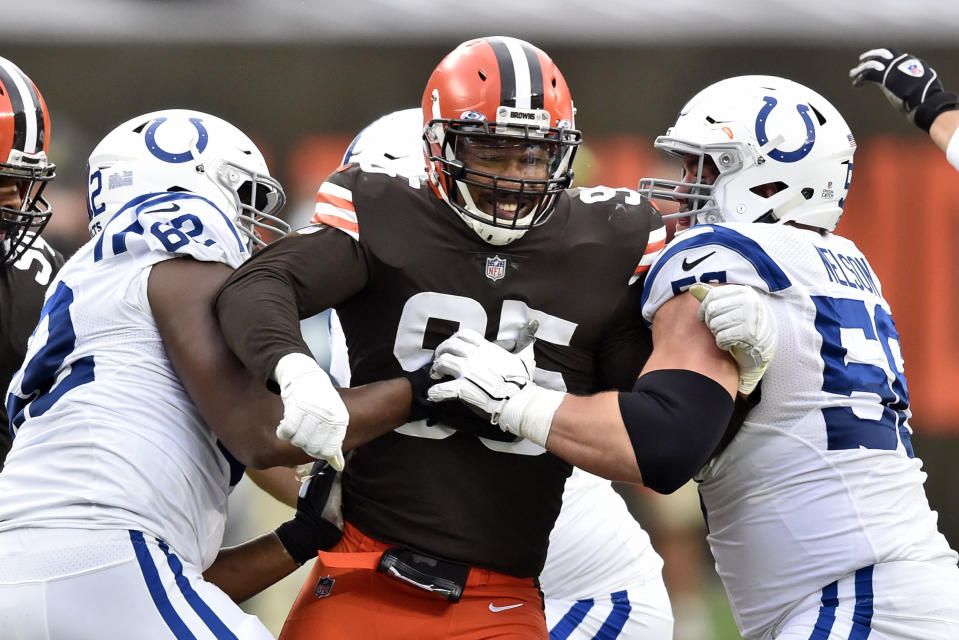 FILE - Cleveland Browns defensive end Myles Garrett (95) rushes the passer during the first half of an NFL football game against the Indianapolis Colts in Cleveland, in this Sunday, Oct. 11, 2020, file photo. Browns defensive star Myles Garrett was activated from the COVID-19 list after missing two games, clearing the end and sack specialist to return this week against Tennessee. (AP Photo/David Richard, File)