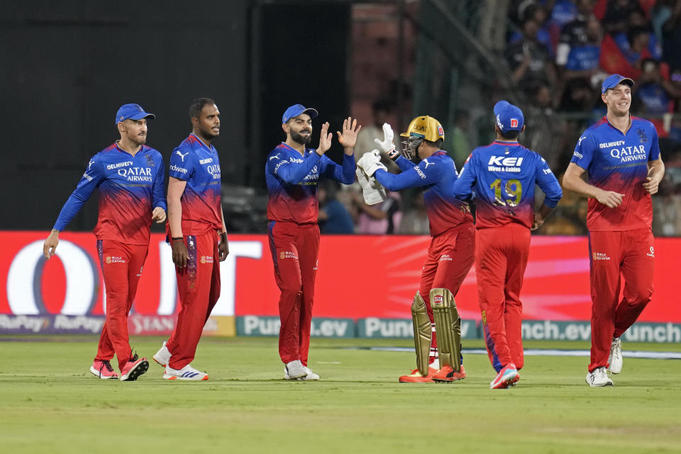 Royal Challengers Bengaluru's Virat Kohli, third left, celebrates with teammates after taking the catch to dismiss Punjab Kings' captain Shikhar Dhawan during the Indian Premier League cricket match between Royal Challengers Bengaluru and Punjab Kings in Bengaluru, India, Monday, March 25, 2024. (AP Photo/Aijaz Rahi)