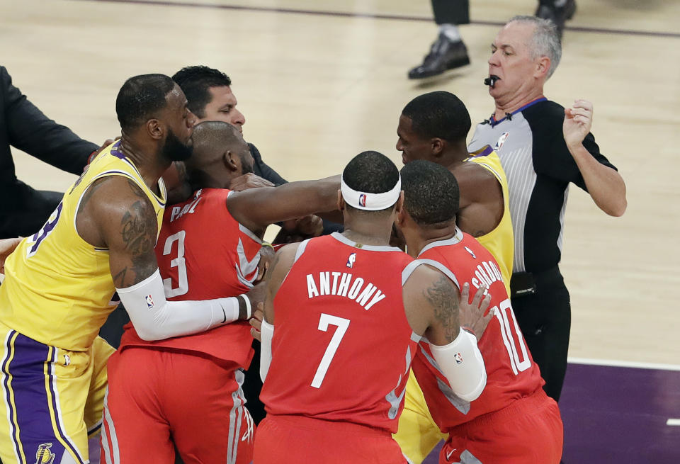 Houston Rockets’ Chris Paul, second from left, fights with Los Angeles Lakers’ Rajon Rondo, top right, during the second half of an NBA basketball game Saturday, Oct. 20, 2018, in Los Angeles. (AP Photo/Marcio Jose Sanchez)