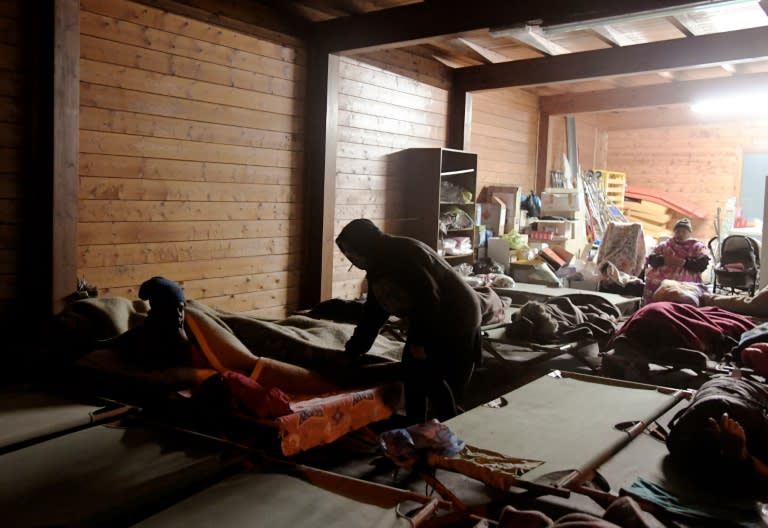 People gather to sleep in a secured area after earthquakes in the village of Visso, central Italy