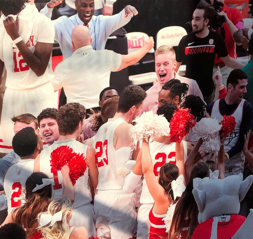 Bradley center Rienk Mast (in red polo shirt, shouting) caught up in the Braves celebration in 2019-20, when he was a redshirt freshman and the team earned an NCAA bid.