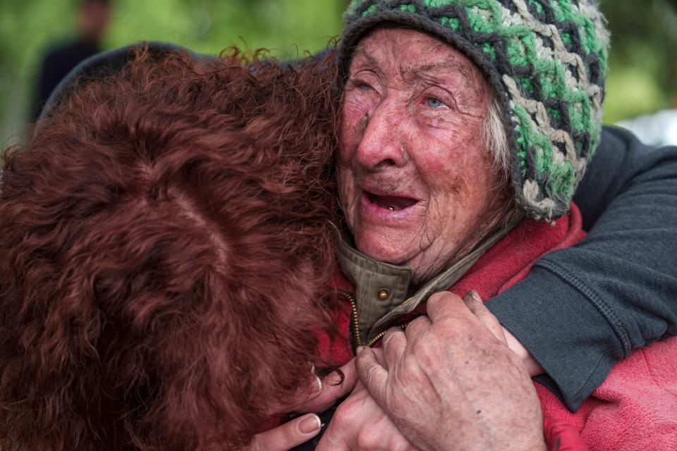 Tetiana, 82, cries with her daughter as she is evacuated from Vovchansk, Ukraine, last weekend (AP)