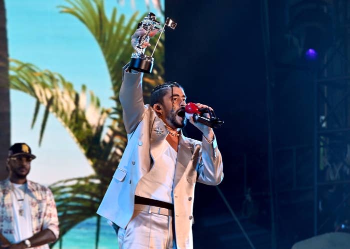 Bad Bunny holds up his VMA on stage