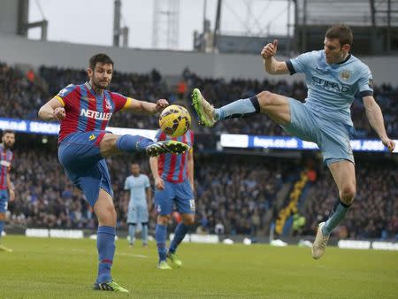 Manchester City's James Milner (R) challenges Crystal Palace's Scott Dann during their English Premier League soccer match at the Etihad Stadium in Manchester, northern England December 20, 2014. REUTERS/Phil Noble