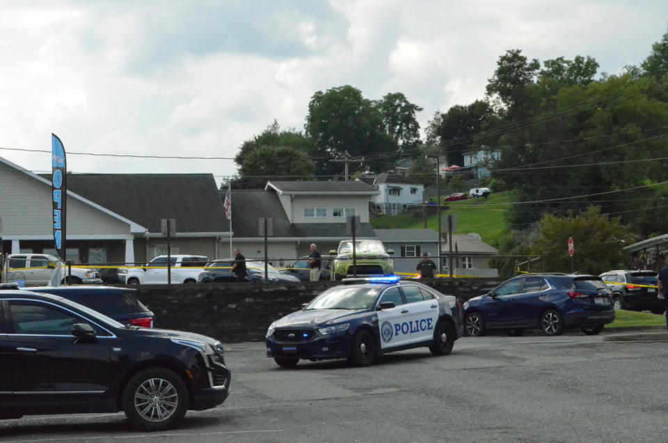 FILE - A heavy police presence is on scene of a Nutter Fort, W.Va., funeral home, Aug. 24, 2022, after an officer-involved shooting of a fugitive suspect occurred in the funeral home's parking lot. Charges will not be brought against members of a West Virginia task force who fatally shot a pallbearer at his father’s funeral after an investigation found the fugitive was reaching for a concealed weapon, a special prosecutor said Tuesday, April 18, 2023. (Josiah Cork/The Exponent via AP, File)