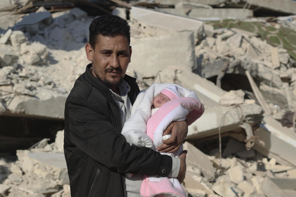 Khalil al-Sawadi holds Afraa, a baby girl who was born under the rubble caused by an earthquake that hit Syria and Turkey, in the town of Jinderis, Aleppo province, Syria.  / Credit: Ghaith Alsayed / AP