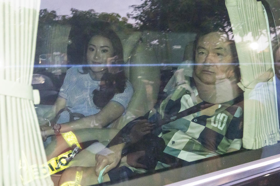 FILE - Former Thai Prime Minister Thaksin Shinawatra, right, sits in a vehicle with his daughter Paetongtarn in front of his residence after being released on parole, Sunday, Feb. 18, 2024, in Bangkok, Thailand. Thaksin Shinawatra, a controversial former Prime Minister of Thailand, made his dramatic return to Thailand last year after nearly a decade of self-imposed exile. Although he was detained in a hospital and never appeared in the public eye for six months after his arrival, his presence in the country alone brings a turmoil into Thai politics like no other politician could ever achieve (AP Photo/Wason Wanichakorn File)