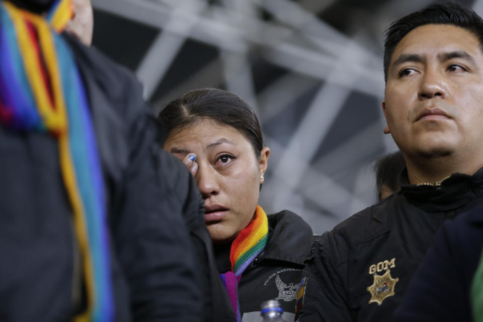 A policewoman, who was detained by anti-governments protesters, cries while standing on a stage at the Casa de Cultura, in Quito, Ecuador, Thursday, Oct. 10, 2019. Thousands of protesters staged anti-government rallies seeking to intensify pressure on Ecuador's president after a week of unrest sparked by fuel price hikes. (AP Photo/Fernando Vergara)