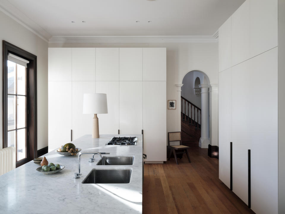 A kitchen island with a table lamp in the center