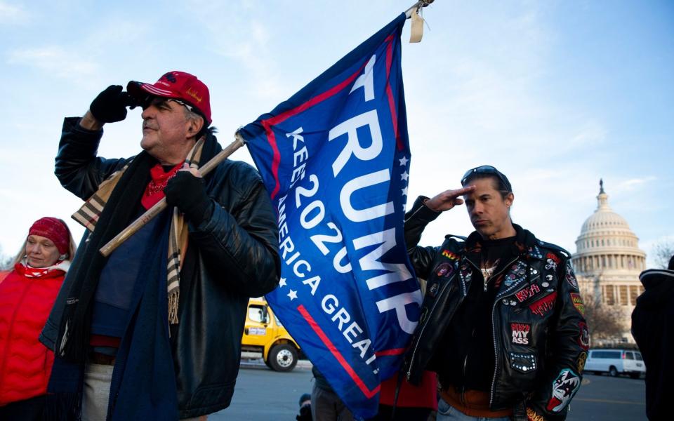 Trump supporters salute at a makeshift monument at the West Front of the US Capitol, for Ashli Babbitt - EPA