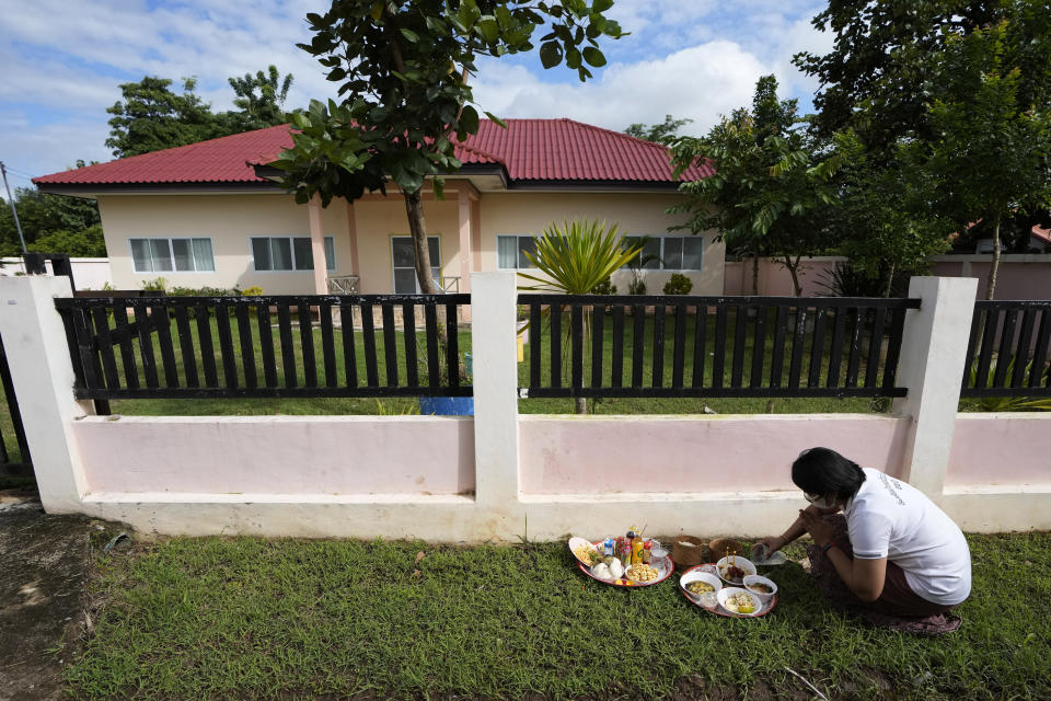 A relative of a victim prays in front of former childcare center after the Buddhist ceremony in the rural town of Uthai Sawan, in Nong Bua Lamphu province, northeastern Thailand, Friday, Oct. 6, 2023. A memorial service takes place to remember those who were killed in a grisly gun and knife attack at a childcare center. A former police officer killed 36 children and teachers in the deadliest rampage in Thailand's history one year ago. (AP Photo/Sakchai Lalit)