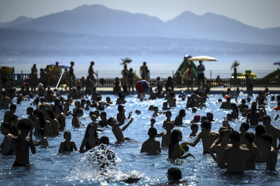 People cool off in the water during hot weather at the public swimming pool Bellerive on the shore of the Geneva Lake, in Lausanne, Switzerland, Wednesday, Aug. 23, 2023. The city of Lausanne has decided to open its swimming pools free of charge as many parts of Switzerland have been experiencing a period of extreme heat. (Laurent Gillieron/Keystone via AP)