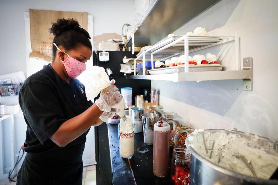 Tia Chancellor, of Georgetown, Ky., owner of Sweet Matriarch Bakery works to create one of their Cattywampus Milkshakes for a customer, Saturday, Aug. 15, 2020. She announced that she has closed her Cattywampus Station in Lexington Green after three years.