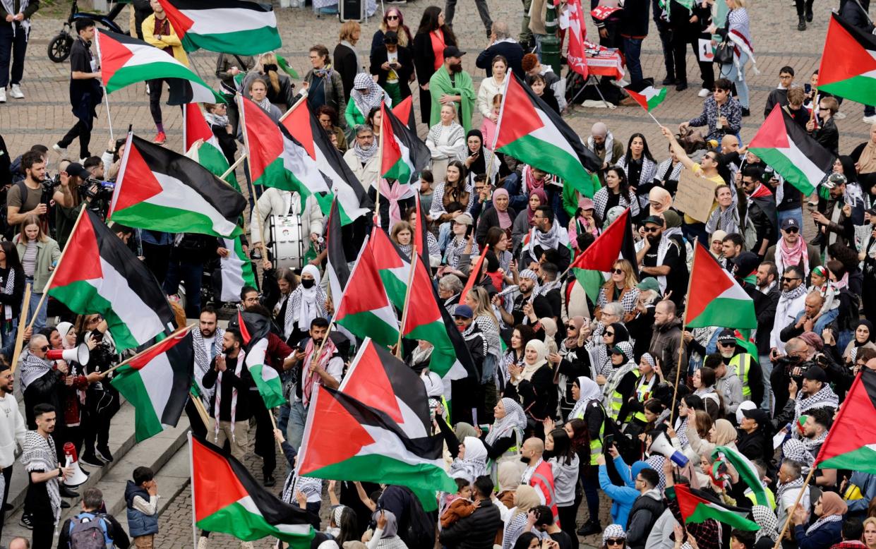 Protesters waving Palestinian flags