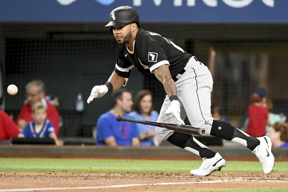 Chicago White Sox's Leury Garcia bunts for a single in the fourth inning during a baseball game against the Texas Rangers in Arlington Texas, Sunday, Sept. 19, 2021. (AP Photo/Matt Strasen)