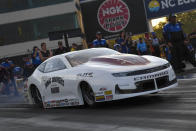 In this photo provided by the NHRA, Pro Stock's Aaron Stanfield races to the provisional No. 1 position in his first-round qualifying run in his Janac Brothers Chevrolet Camaro at the DeWalt NHRA Carolina Nationals at zMAX Dragway in Concord, N.C., Friday, Sept. 17, 2021. (Richard H. Shute/NHRA via AP)