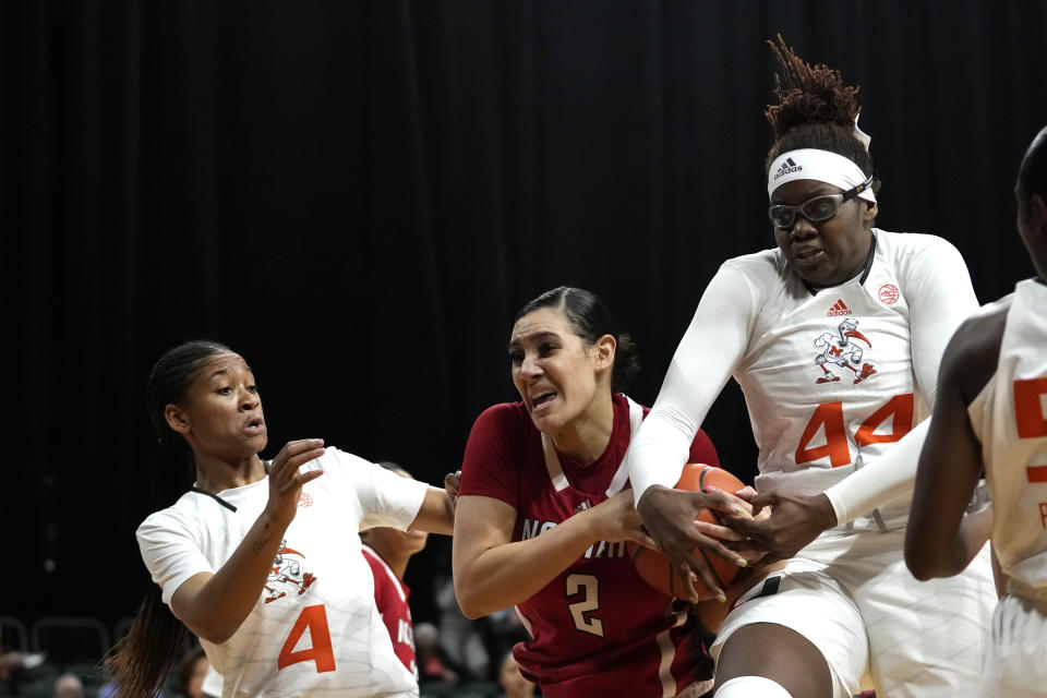 North Carolina State forward Mimi Collins (2) and Miami Miami center Kyla Oldacre (44) fight for possession of the ball during the first half of an NCAA college basketball game Thursday, Jan. 18, 2024, in Coral Gables, Fla. (AP Photo/Lynne Sladky)