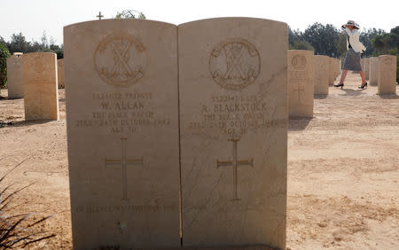 A woman visits graves of World War Two soldiers before a ceremony for the anniversary of the Battle of El Alamein, at El Alamein war cemetery in Egypt, October 20, 2018. REUTERS/Amr Abdallah Dalsh