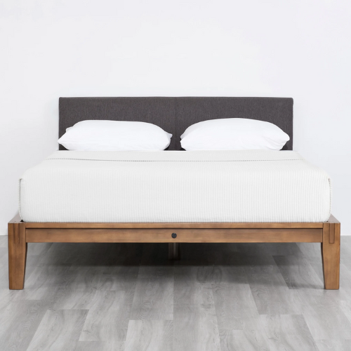 Wooden Thuma bed frame with white covered mattress and two pillows