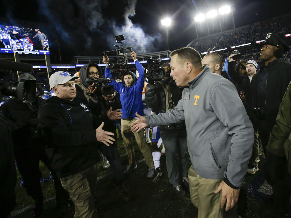 Tennessee head coach Butch Jones greets Kentucky head coach Mark Stoops on the field after Kentucky defeated Tennessee 29-26 in an NCAA college football game Saturday, Oct. 28, 2017, in Lexington, Ky. (AP Photo/David Stephenson)