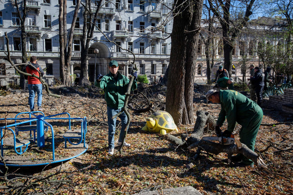 KYIV, UKRAINE - 2022/10/10: Municipal workers clear the damaged playground after a Russian missile attack in central Kyiv. Explosions have been reported in several districts of the Ukrainian capital. At least 11 people died and dozens injured as a result of Russian rocket attacks targeting cities across Ukraine. (Photo by Oleksii Chumachenko/SOPA Images/LightRocket via Getty Images)