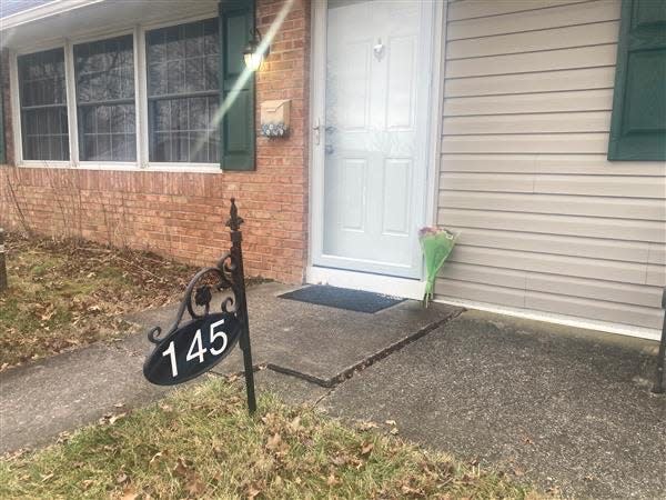 A woman left flowers at the door of the Mohn house on Upper Orchard Drive on Tuesday, leaving her condolences for the family