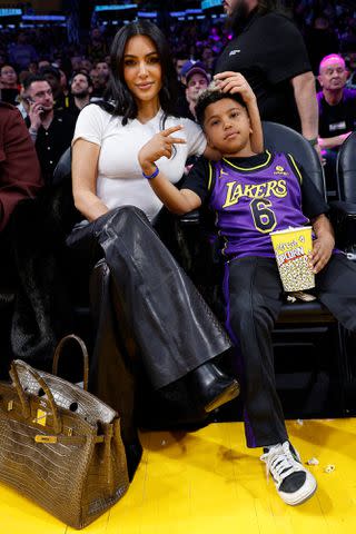 <p>Kevork Djansezian/Getty</p> Kardashian and her son Saint, 8, attended a Los Angeles Lakers game on Saturday