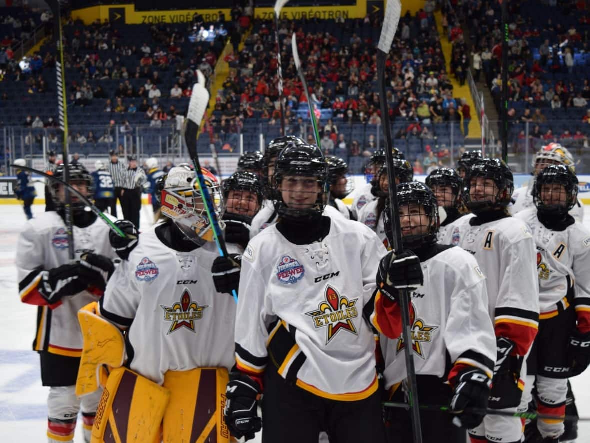 The PeeWee Girls All-Stars celebrate after their first win at the International Pee-Wee Tournament in Quebec City. (Quebec International Pee-Wee Hockey Tournament - image credit)