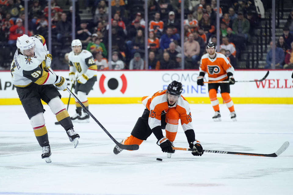 Vegas Golden Knights' Jonathan Marchessault, left, passes the puck against Philadelphia Flyers' Joel Farabee during the second period of an NHL hockey game, Tuesday, March 14, 2023, in Philadelphia. (AP Photo/Matt Slocum)