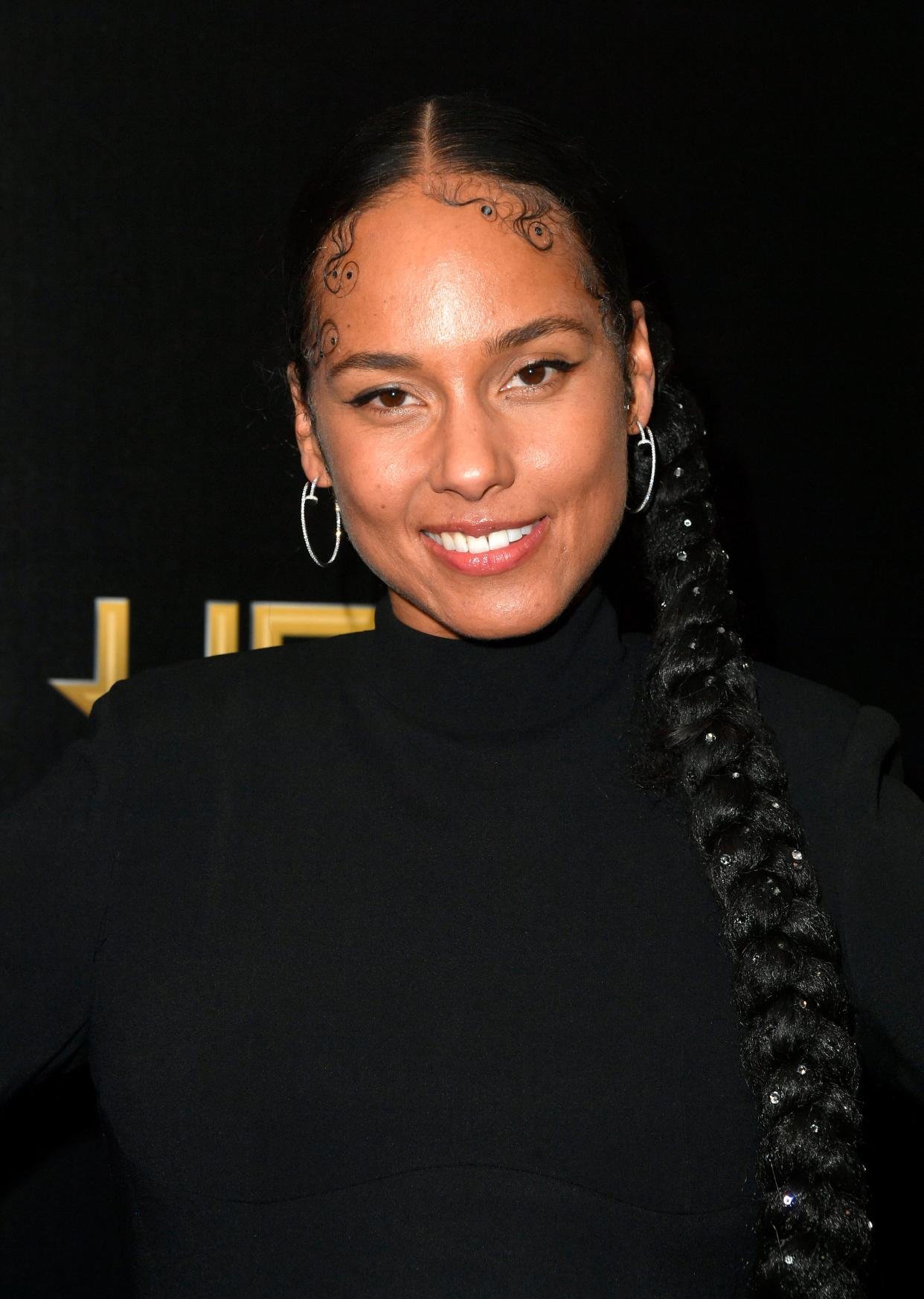 Alicia Keys looks gorgeous as always in a long-sleeve black dress, with braided ponytail.