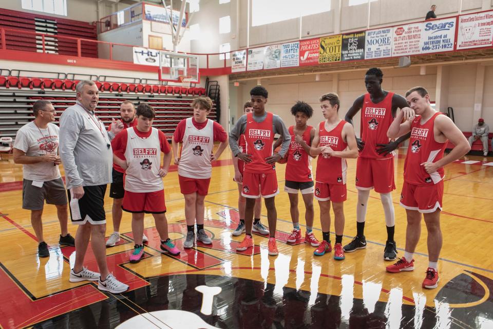 Belfry basketball coach, Mark Thompson, second from left, talks with players at the start of practice. Nov. 10, 2021