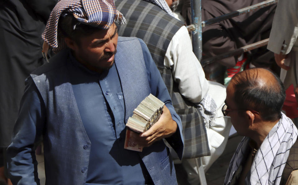 Afghan black market money changers wait for customers in Sarai Shahzada market in Kabul, Afghanistan, Saturday, Sept. 4, 2021. (AP Photo/Wali Sabawoon)