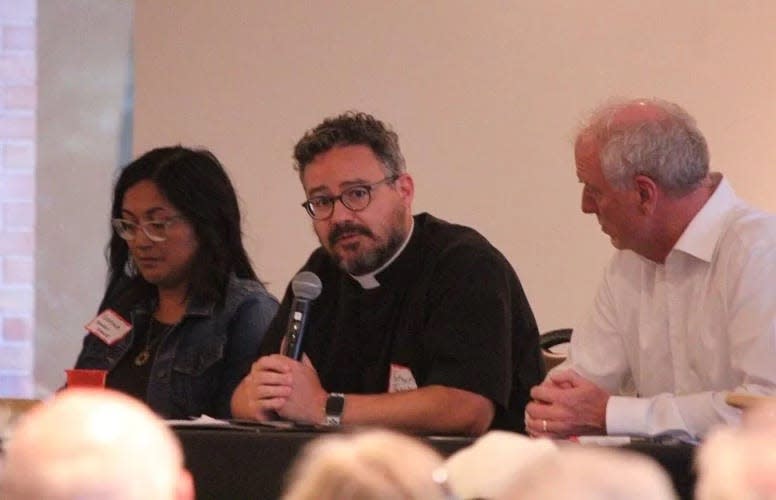 The Rev. Jared Cramer, center, discusses his views on the intersection of faith and politics at Thursday night's Unifying Coalition panel discussion.