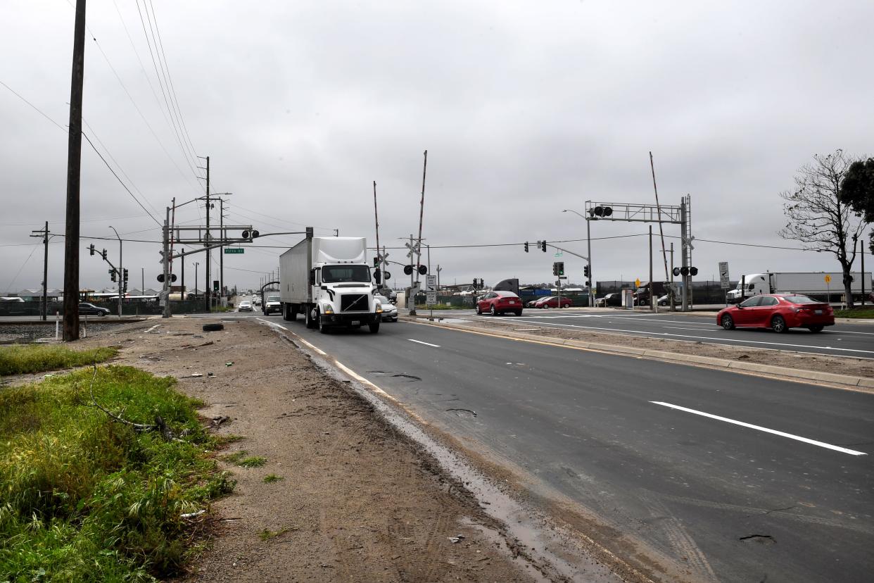 Vehicle drive across railroad tracks at the intersection of Rice Avenue and Fifth Street in Oxnard at the site of a planned overpass in March. The state awarded Oxnard and the Port of Hueneme a combined $95 million to help fund infrastructure projects.