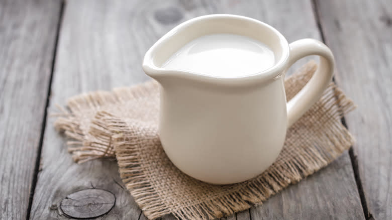 Pitcher of cream on table