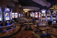 Chairs sit on pallets as some are being removed from electronic slot machines to maintain social distancing between players at a closed Caesars Palace hotel and casino Thursday, May 21, 2020, in Las Vegas. Casino operators in Las Vegas are awaiting word when they will be able to reopen after a shutdown during the coronavirus outbreak. (AP Photo/John Locher)